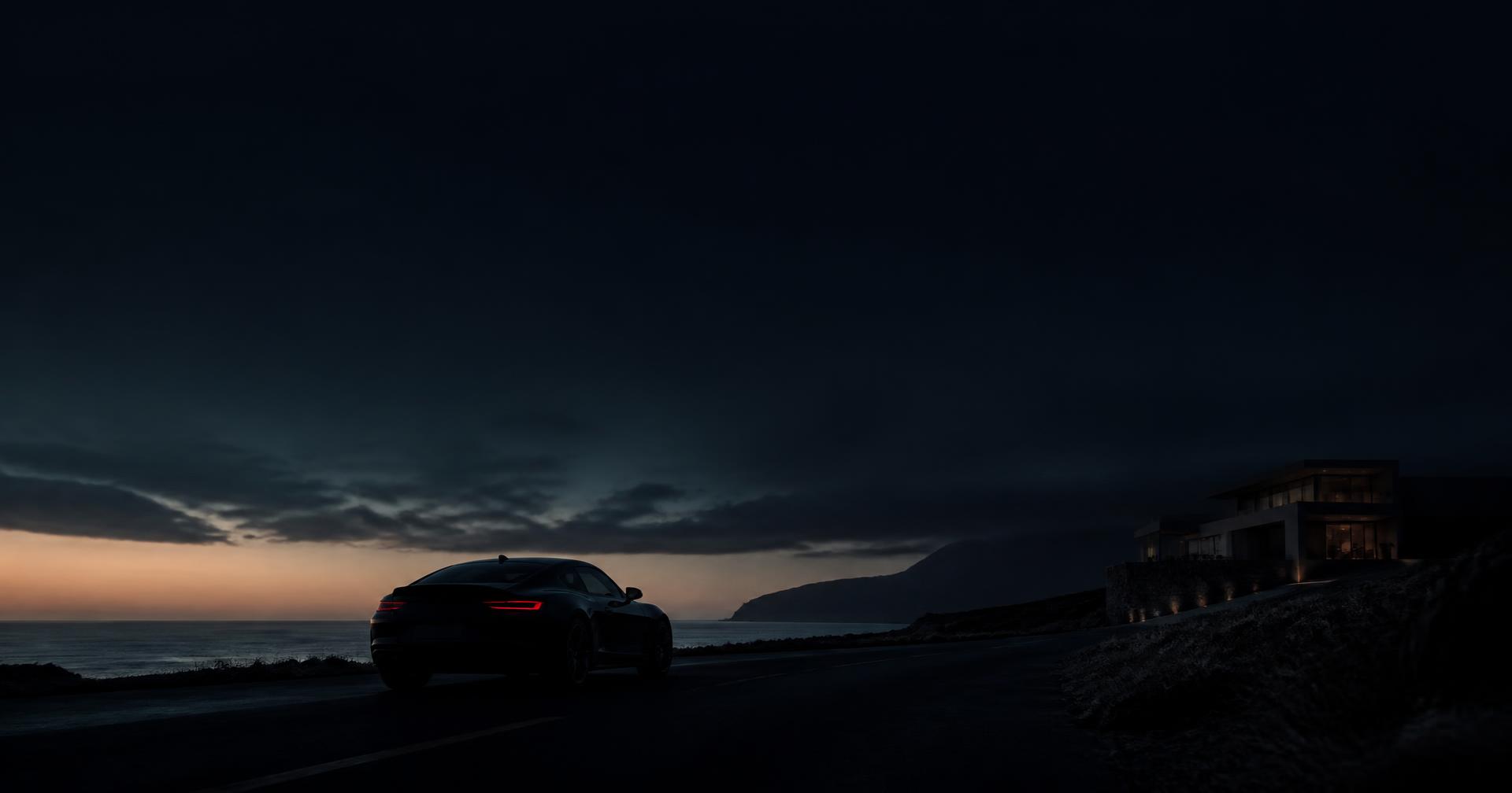 Prestige coupé silhouetted on a coastal road at blue hour